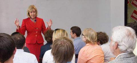 Julie speaking with an audience